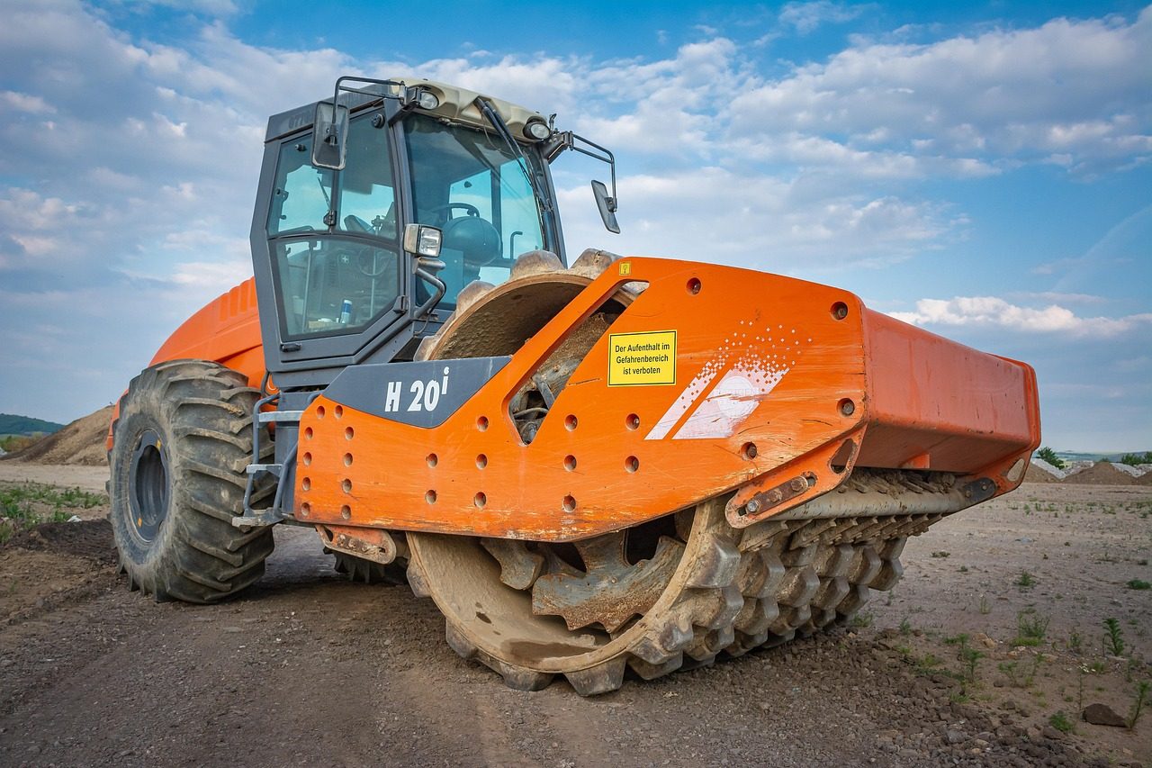 A compaction roller parked on a resurfacing job site
