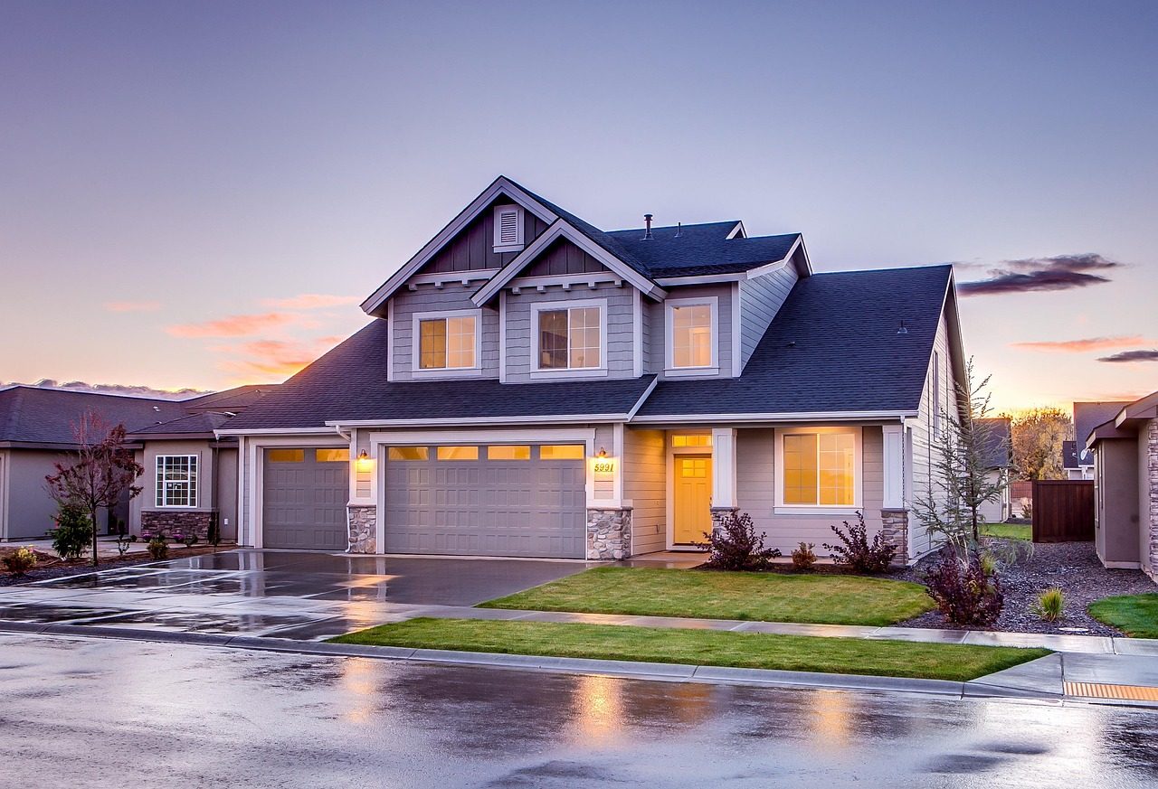 A freshly sealed, glossy black asphalt driveway at a suburban home